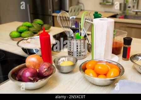 kitchen utensils and vegetables on the table in the home kitchen Stock Photo