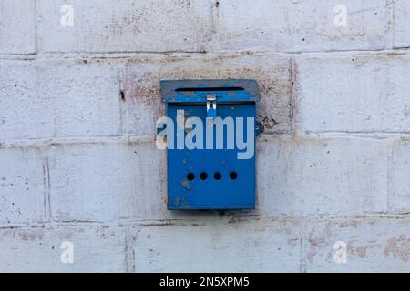 Mailbox blue in retro style on brick wall. old iron mailbox Stock Photo