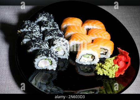 Japanese cuisine, professional culinary, seafood, restaurant menu, food photo art. Delicious sushi rolls set served on plate, copy space. High quality photo Stock Photo