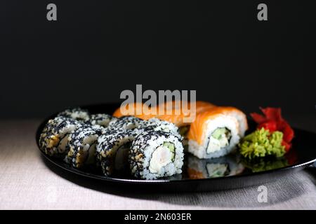 Japanese cuisine, professional culinary, seafood, restaurant menu, food photo art. Delicious sushi rolls set served on plate, copy space. High quality photo Stock Photo