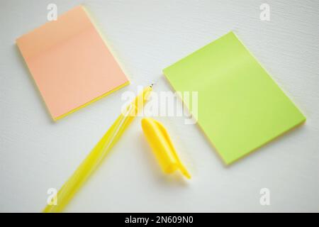 Yellow ballpoint pen and notes on white paper. Stock Photo