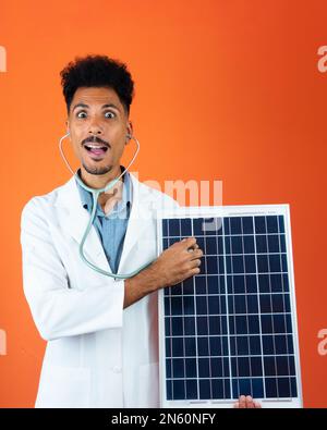 Black Young Doctor Medical Resident With Stethoscope Holding Solar Panel Stock Photo