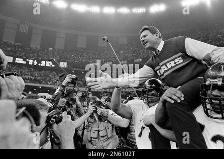 Chicago Bears coach Mike Ditka is restrained by defensive end Richard Dent  (95) from going after the referee after a disputed call on a pass play in  the first half of game