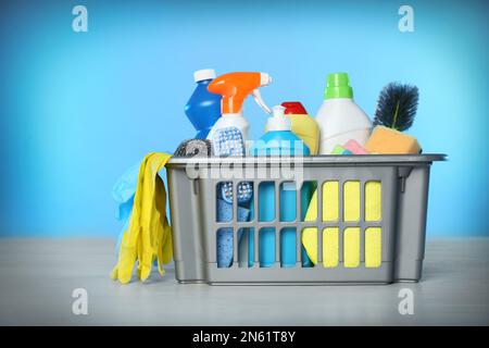 https://l450v.alamy.com/450v/2n61t8y/basket-with-different-cleaning-products-and-supplies-on-light-table-2n61t8y.jpg