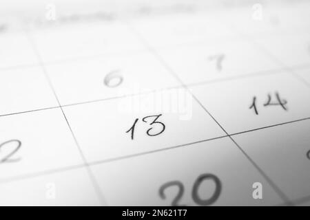 Closeup view of calendar page, focus on Friday 13. Bad luck superstition Stock Photo