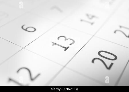 Closeup view of calendar page, focus on Friday 13. Bad luck superstition Stock Photo