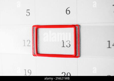 Closeup view of calendar page, focus on Friday 13. Bad luck superstition Stock Photo