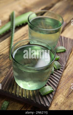 Fresh aloe drink in glasses on wooden table Stock Photo