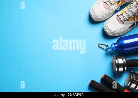 Flat lay composition with sport items on blue background. Space for text Stock Photo