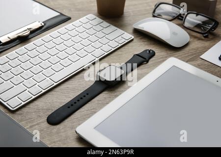 MYKOLAIV, UKRAINE - JULY 20, 2020: Composition with different Apple gadgets on wooden table Stock Photo