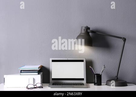 Modern laptop and stationery on table in office. Space for text Stock Photo