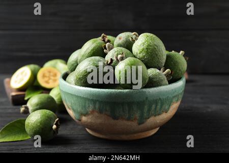 Fresh green feijoa fruits on black wooden table, closeup Stock Photo