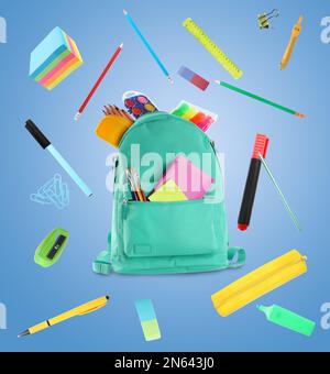 Backpack surrounded by flying school stationery on light blue background Stock Photo