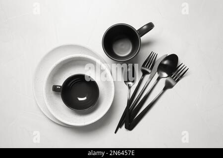 Flat lay composition with dishware and cutlery on white table Stock Photo