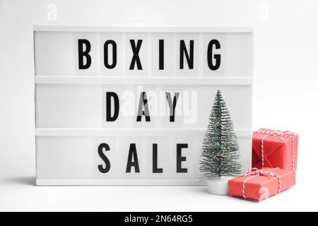 Lightbox with phrase BOXING DAY SALE and Christmas decorations on white background Stock Photo