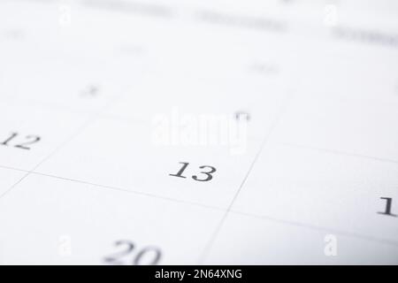 Closeup view of calendar page, focus on Friday 13. Bad luck superstition Stock Photo