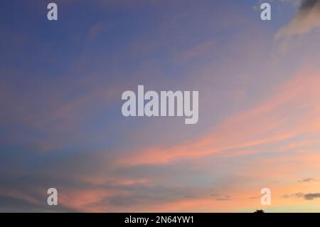 Real amazing panoramic sunrise or sunset sky with gentle colorful clouds Stock Photo