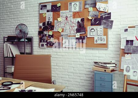 Modern detective office with workplace and board Stock Photo - Alamy
