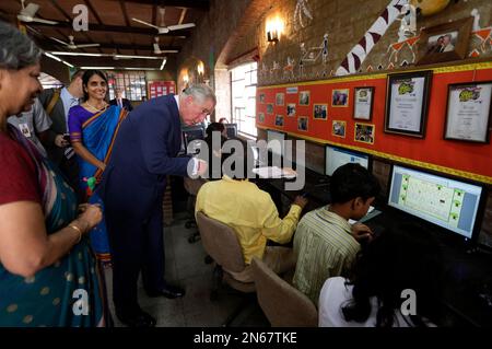 Britain's Prince Charles speaks with a student during his visit to Katha Lab School, a school for underprivileged children, in New Delhi, India, Friday, Nov. 8, 2013. Charles and his wife Camilla, the Duchess of Cornwall, are on a nine-day visit to India. (AP Photo/Saurabh Das)