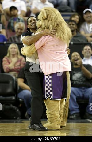 Official Blll Kennedy is hugged by Sacramento Kings mascot