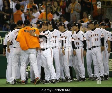 Yomiuri Giants manager Tatsunori Hara, center watches an opening