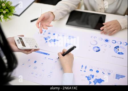 Cropped image of a businesspeople or financial analysts analyzing financial data, discussing and brainstorming a new financial plan in the meeting. Stock Photo