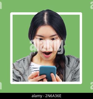 Asian woman, wow and phone with frame border with green background looking at mobile text. Online communication, digital news and shocked face of a Stock Photo