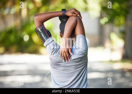 Black woman, fitness and stretching arms for running, cardio exercise or workout preparation in nature. African American female in warm up arm stretch Stock Photo