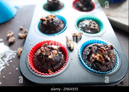 Freshly baked muffins , Cupcake molds . Homemade baking concept Stock Photo