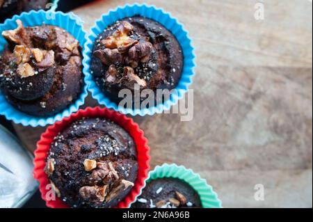 Freshly baked muffins , Cupcake molds . Homemade baking concept, top view. Stock Photo