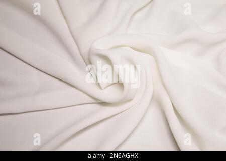 White fabric background. White cloth waves background texture. White fabric cloth textile material. Stock Photo