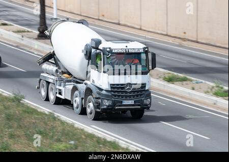 A White Mercedes Arocs concrete mixer on road Stock Photo