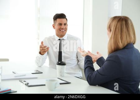 Office employees talking at table during meeting Stock Photo