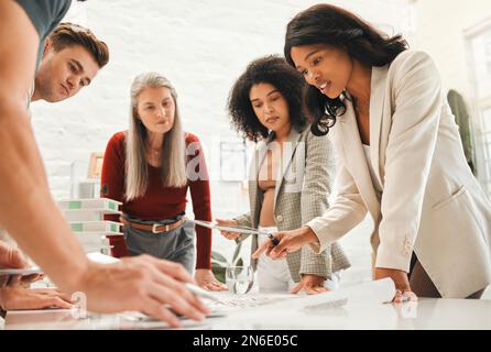 Group of architects talking building plan. Group of engineers discussing a blueprint. Diverse businesspeople collaborate on a building plan. Creative Stock Photo