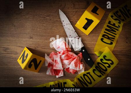 Flat lay composition with evidences and crime scene markers on wooden background Stock Photo