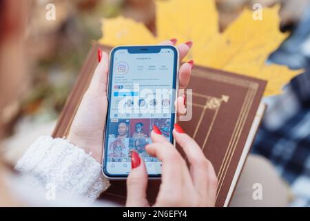 KIEV, UKRAINE. FEBRUARY 10, 2023 : The main logo popular apps Instagram, Facebook on your smartphone screen in female hands. High quality photo Stock Photo