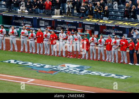 St. Louis Cardinals stand for the National Anthem, wearing pink