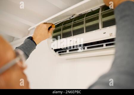 Solar panels, construction and man doing installation of a grid for renewable energy and electricity. Building, house and handyman fitting a Stock Photo