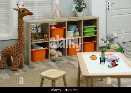 Cute child's room interior with toys and wooden furniture Stock Photo