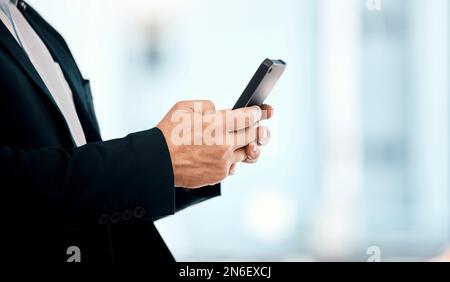Businessman, phone and hands typing in networking, communication or social media for corporate idea on mockup. Hand of male manager or CEO texting on Stock Photo