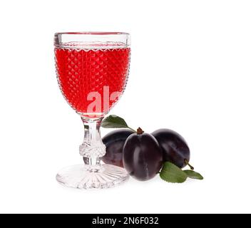 Delicious plum liquor and ripe fruits on white background. Homemade strong alcoholic beverage Stock Photo