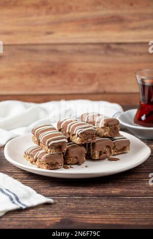 Chocolate covered cookies. Bakery products. Chocolate cookies on wood background. close up Stock Photo
