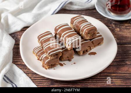 Chocolate covered cookies. Bakery products. Chocolate cookies on wood background. close up Stock Photo