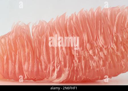 close-up macro view of ripe pomelo fruit, citrus maxima, teardrop or pear shaped large asian citrus fruit flesh or pulp isolated on white background Stock Photo