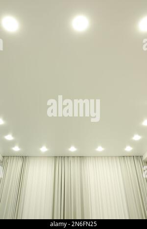 White stretch ceiling with spot lights in room Stock Photo