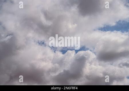 closeup of storm clouds with dark areas and patches of blue sky in an interesting pattern Stock Photo