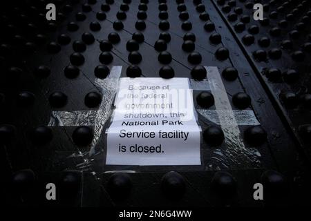 A sign posted on a door at Castle Clinton National Monument reads, 'Because of the federal government shutdown, this National Park Service facility is closed,' Tuesday, Oct. 1, 2013 in New York. 'Closed' signs and barricades sprang up at the Lincoln Memorial, and national parks and federal workplaces across the country were following suit. (AP Photo/Mark Lennihan)