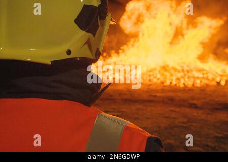 Firefighter putting out a fire. Accident and disaster. Protection Stock Photo