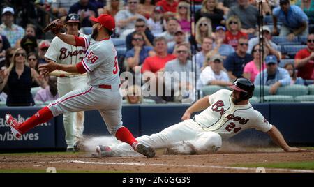 Atlanta Braves' Evan Gattis, right, high-fives teammate Tommy La Stella  after hitting a home run in the second inning of a baseball game against  the Miami Marlins, Sunday, Aug. 31, 2014, in