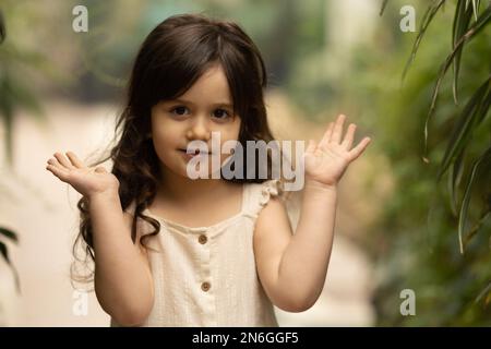 a little girl walks in the botanical garden. happy baby and palm trees Stock Photo